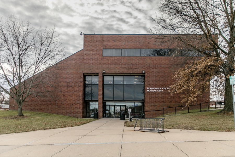 A large brick building with a modern design houses the Independence City Municipal Court, featuring tall windows and leafless trees.