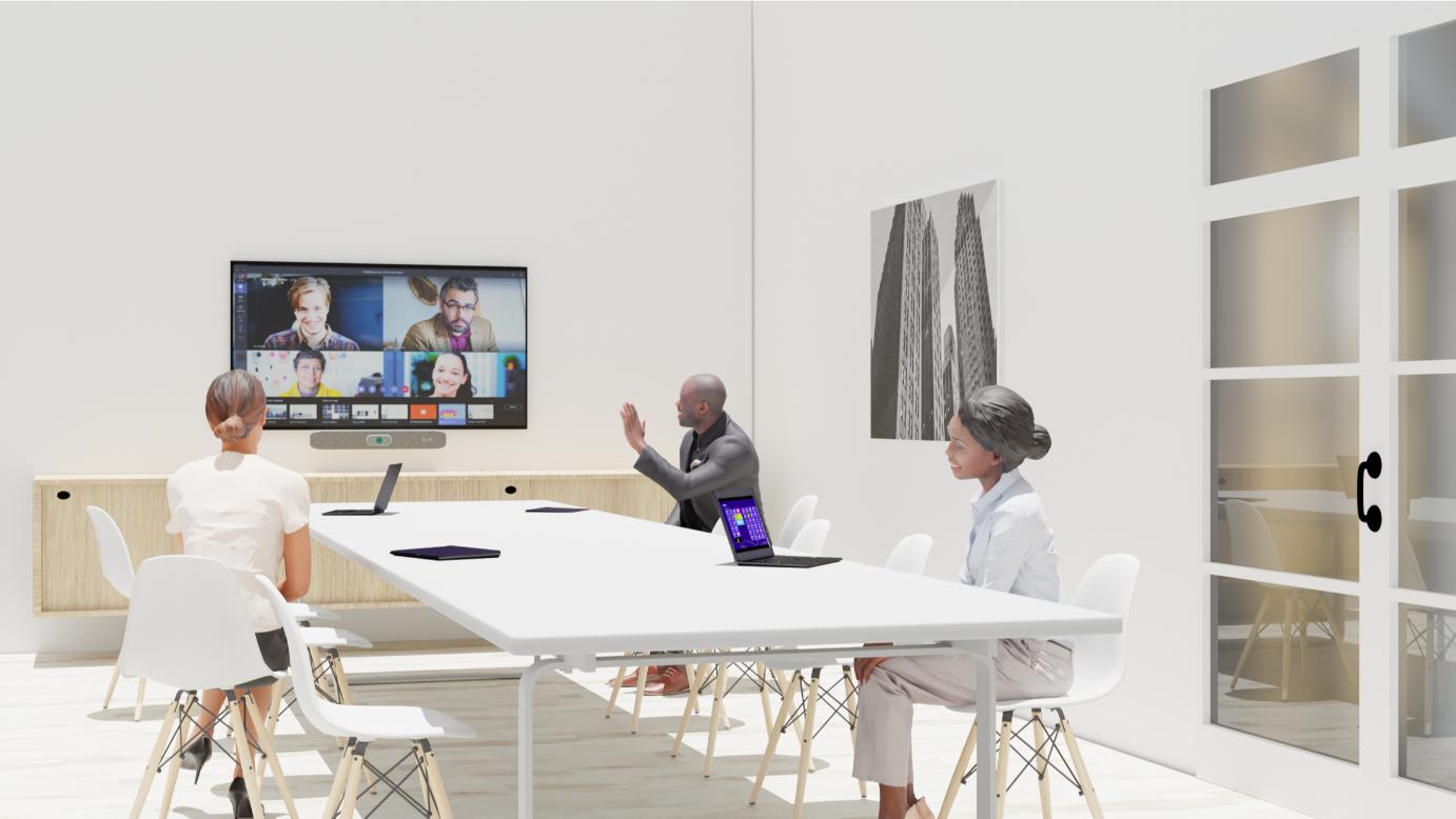 Three at a table video conference with six on screen; laptops, tablets present; large photo on wall.
