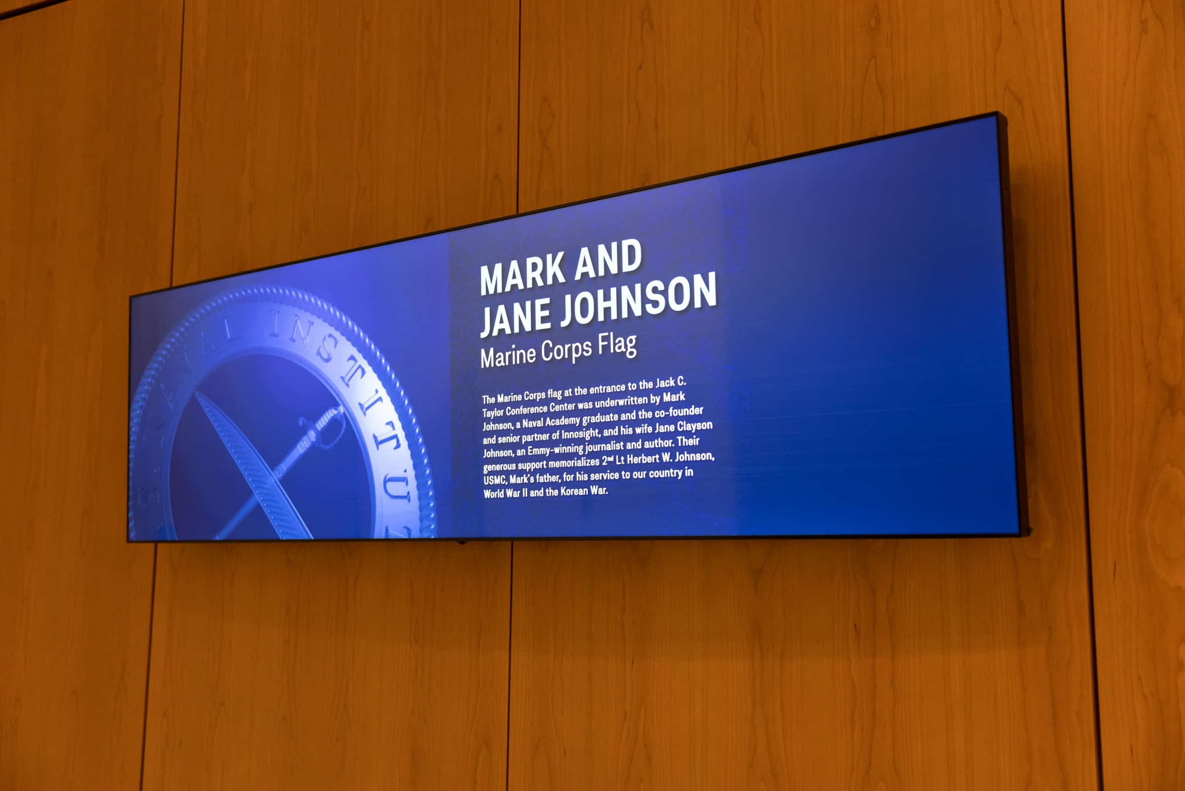 Mark & Jane Johnsons Marine Corps Flag proudly displayed. (Digital display, partial blue seal on left).